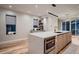 Bright kitchen features a modern island with built-in microwave and view of outdoor patio at 3232 W 16 Ave, Denver, CO 80204