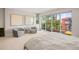 Bright main bedroom features large windows, patio access, and neutral tones for a calm, inviting space at 3232 W 16 Ave, Denver, CO 80204