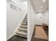 Hallway and carpeted staircase with modern details and dark floors at 3232 W 16 Ave, Denver, CO 80204