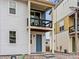 Charming two-story home featuring a covered balcony and a vibrant blue front door at 6162 W 28Th Ct, Wheat Ridge, CO 80214