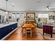 Open-concept kitchen and living area with hardwood floors, modern lighting, and stylish furniture at 6162 W 28Th Ct, Wheat Ridge, CO 80214