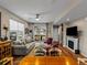 Bright living room with hardwood floors, comfortable seating, fireplace, and access to an outdoor balcony at 6162 W 28Th Ct, Wheat Ridge, CO 80214