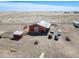 Aerial view of expansive property featuring a red barn, sheds, and countryside views at 7172 S Oakleaf St, Bennett, CO 80102