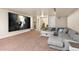 Finished basement with a large screen projector, comfortable seating, and stairs to the upper level at 7172 S Oakleaf St, Bennett, CO 80102