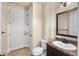 Bathroom includes dark wood vanity, toilet, and white door for convenience at 7172 S Oakleaf St, Bennett, CO 80102