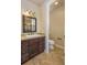 Bathroom featuring a custom vanity, mirror, and tile floor at 7172 S Oakleaf St, Bennett, CO 80102
