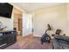 Bedroom includes work out equipment and doorway to bathroom, perfect for relaxation and exercise at 7172 S Oakleaf St, Bennett, CO 80102