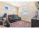 Bedroom features comfortable seating, work out equipment, and multiple windows at 7172 S Oakleaf St, Bennett, CO 80102