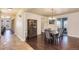 Dining room with hardwood floors, chandelier, with ample natural light, perfect for formal gatherings at 7172 S Oakleaf St, Bennett, CO 80102