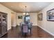 Formal dining room featuring hardwood floors, elegant lighting, and ample space for entertaining guests at 7172 S Oakleaf St, Bennett, CO 80102