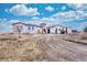 Exterior elevation shows the unique architecture, beautiful curb appeal, and mature landscaping at 7172 S Oakleaf St, Bennett, CO 80102