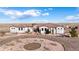 Elegant single-story home with a tile roof, circular driveway, and desert landscaping at 7172 S Oakleaf St, Bennett, CO 80102