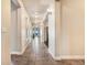 Long hallway with tiled floors, recessed lighting, and access to multiple rooms at 7172 S Oakleaf St, Bennett, CO 80102