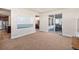 Cozy living room with a sliding door to a patio and open to the kitchen with stainless steel appliances at 7172 S Oakleaf St, Bennett, CO 80102
