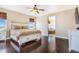 Comfortable main bedroom featuring a ceiling fan, hard wood flooring, and windows at 7172 S Oakleaf St, Bennett, CO 80102
