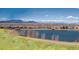 Aerial view of a neighborhood and lake with a mountain range in the distance with beautiful blue skies at 2329 Lakeshore Ln # 14, Superior, CO 80027