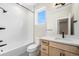 Well-lit bathroom featuring white subway tiles, black fixtures, and wood cabinet with a white countertop at 2329 Lakeshore Ln # 14, Superior, CO 80027