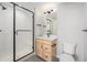 Modern bathroom featuring a glass-enclosed shower, wood vanity, and sleek fixtures at 2329 Lakeshore Ln # 14, Superior, CO 80027