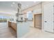 Modern kitchen with an island featuring a cooktop and views of the dining and living areas at 2329 Lakeshore Ln # 14, Superior, CO 80027