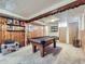 Recreational basement features a pool table, wood paneling, and a drop ceiling at 2330 W 46Th Ave, Denver, CO 80211