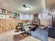 Inviting basement with a brick fireplace, wood paneling, and decorative wall art at 2330 W 46Th Ave, Denver, CO 80211