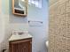 Compact bathroom with tiled walls, a wood-framed mirror, and essential fixtures at 2330 W 46Th Ave, Denver, CO 80211