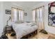 Well-lit bedroom with hardwood floors, neutral decor, and ample natural light at 2330 W 46Th Ave, Denver, CO 80211