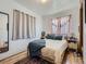 Comfortable bedroom with hardwood floors, soft curtains, and natural light at 2330 W 46Th Ave, Denver, CO 80211