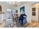 Bright dining area with hardwood floors, modern chandelier, and sliding door to outdoor space at 2330 W 46Th Ave, Denver, CO 80211