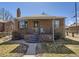 Charming brick home featuring a cozy front porch, bay window, and manicured landscaping at 2330 W 46Th Ave, Denver, CO 80211
