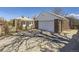Exterior view of the detached brick garage and driveway, complete with a secure fence and gate at 2330 W 46Th Ave, Denver, CO 80211