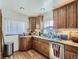 Corner kitchen featuring wooden cabinets, stainless steel appliances, and granite countertops at 2330 W 46Th Ave, Denver, CO 80211