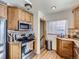 Well-lit kitchen featuring wooden cabinets, stainless steel appliances, and granite countertops at 2330 W 46Th Ave, Denver, CO 80211