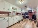 Basement kitchenette boasts ample white cabinetry, butcher block countertops, and unique mosaic tile backsplash at 2330 W 46Th Ave, Denver, CO 80211