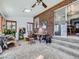 Bright sun room with brick accent wall, multiple windows, and direct access to the home's exterior at 2330 W 46Th Ave, Denver, CO 80211