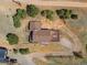 Aerial view of a well-maintained house with a large deck surrounded by lush greenery at 24170 Matterhorn Dr, Indian Hills, CO 80454
