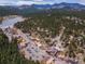 Scenic aerial view of a charming mountain town and forested landscape at 24170 Matterhorn Dr, Indian Hills, CO 80454