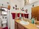 Bathroom with a single sink, decorative elements, and window at 24170 Matterhorn Dr, Indian Hills, CO 80454
