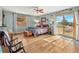 Comfortable bedroom with a ceiling fan, wood floors, and access to an outdoor deck at 24170 Matterhorn Dr, Indian Hills, CO 80454