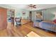 Spacious bedroom with hardwood floors and colorful decor and views into the living space at 24170 Matterhorn Dr, Indian Hills, CO 80454
