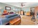 Bedroom with hardwood floors, large windows, eclectic decor, and access to the bathroom at 24170 Matterhorn Dr, Indian Hills, CO 80454