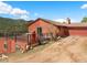 Charming home with attached garage and deck with a mountain view at 24170 Matterhorn Dr, Indian Hills, CO 80454