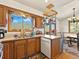 Kitchen area leading to the dining space and showing wood cabinetry, mountain views from the window at 24170 Matterhorn Dr, Indian Hills, CO 80454