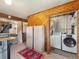 Functional laundry area with washer, dryer, and storage cabinets at 24170 Matterhorn Dr, Indian Hills, CO 80454