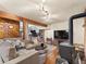 Open-concept living area with a fireplace, television, and an adjacent workout space at 24170 Matterhorn Dr, Indian Hills, CO 80454