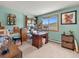 Comfortable office space with a desk, bookshelves, and lots of decor at 24170 Matterhorn Dr, Indian Hills, CO 80454