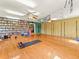 Spacious studio with hardwood floors, ceiling fans, yoga accessories and extensive bookshelves at 24170 Matterhorn Dr, Indian Hills, CO 80454