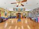 Large studio space with hardwood floors, shelving, windows, yoga mat and accessories at 24170 Matterhorn Dr, Indian Hills, CO 80454