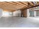 Spacious unfinished basement with concrete floor and exposed wood ceiling at 4428 S Kalispell Cir, Aurora, CO 80015