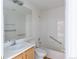 Bathroom featuring a tub with white tiled surround, and neutral-colored vanity at 4428 S Kalispell Cir, Aurora, CO 80015